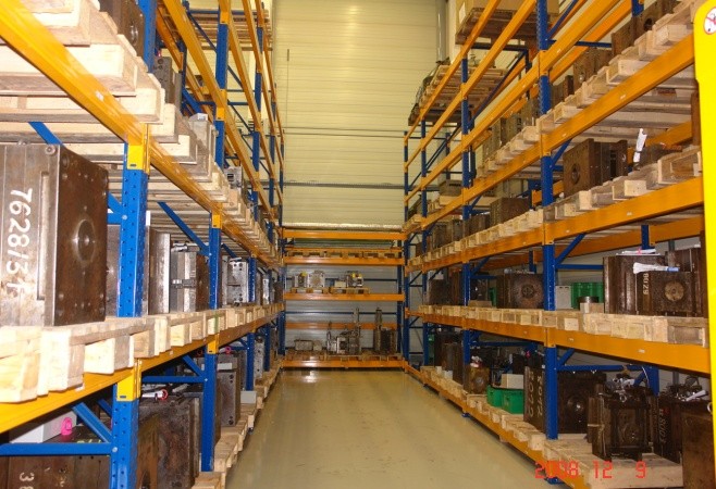 Injection molds stored on racks in the toolroom