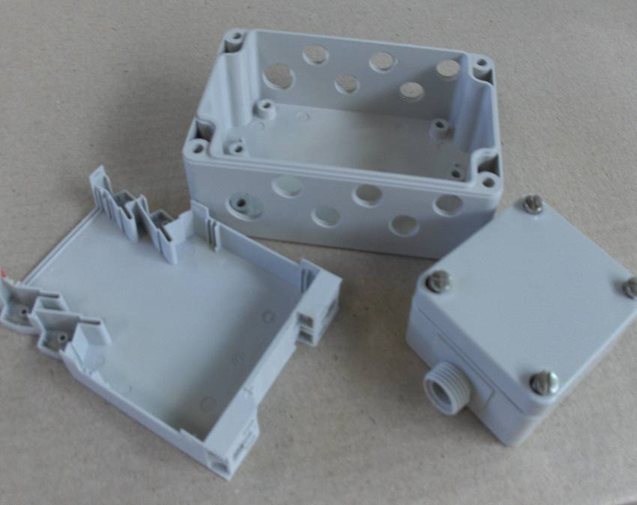 Injection-moulded junction boxes with integrated cable-gland bosses